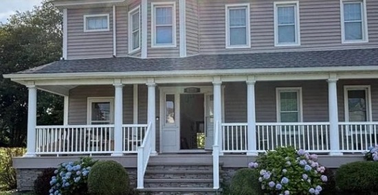 Cropped exterior detail of the front porch and facade at 516 2nd Avenue, from the supplied property flyer; the roof and full exterior are not shown.